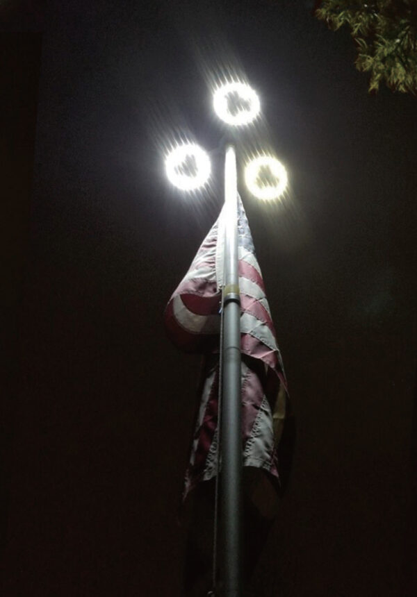 triple solar flagpole light at night