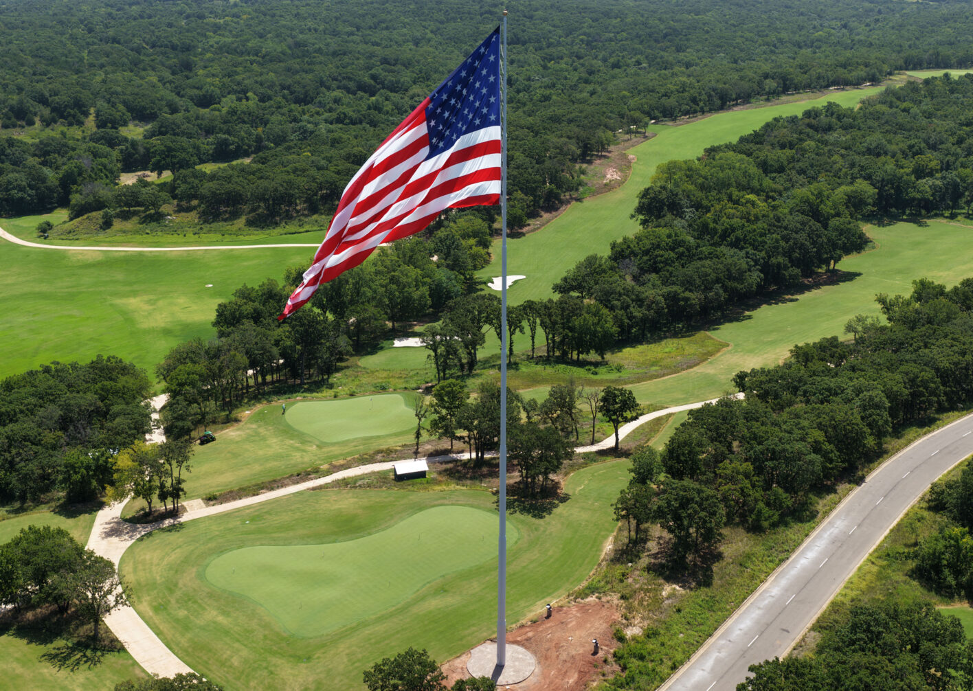 Aerial view of American flag over golf course